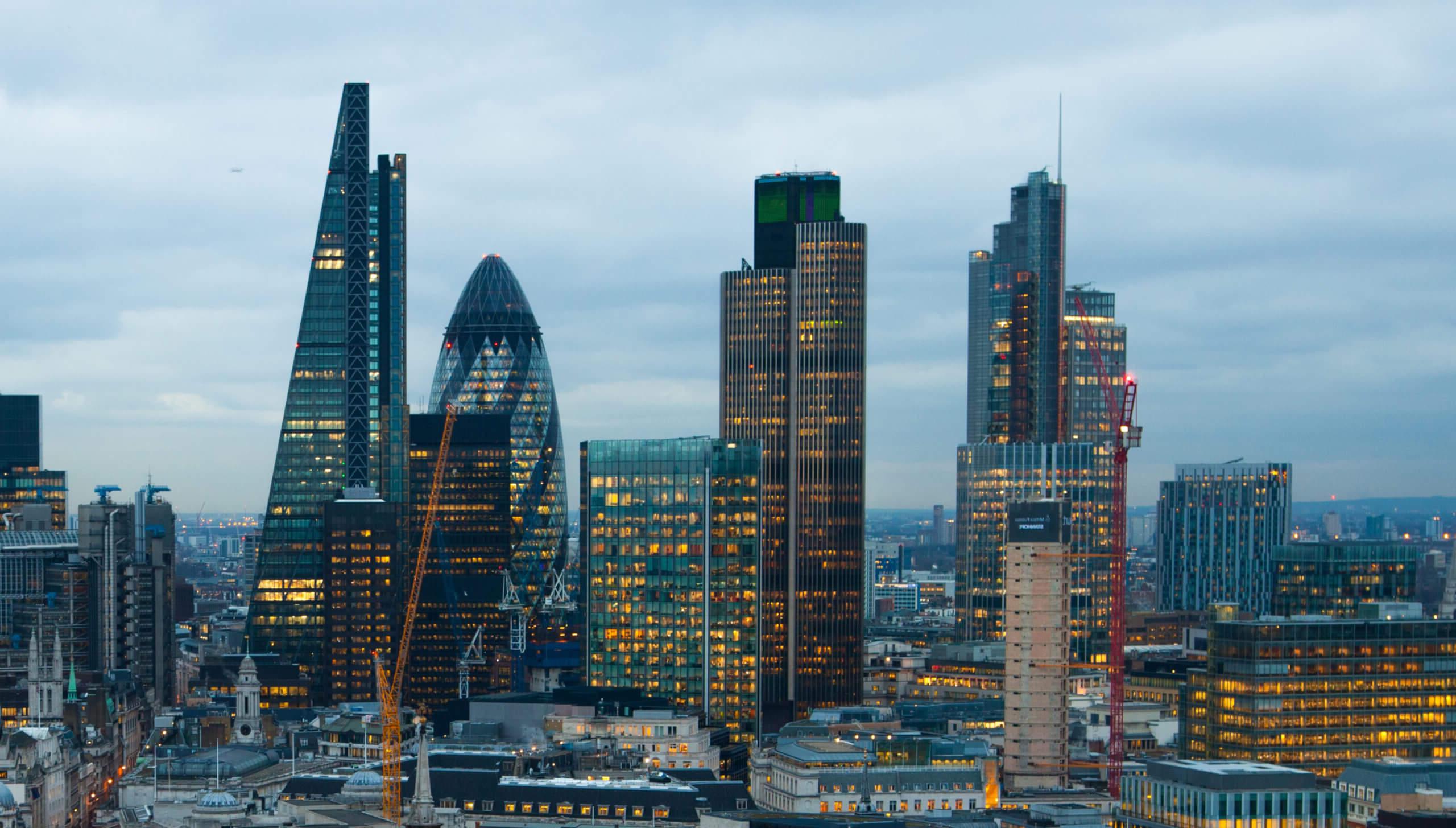 Cityscape view of central London at dusk, including the Shard and the Gherkin